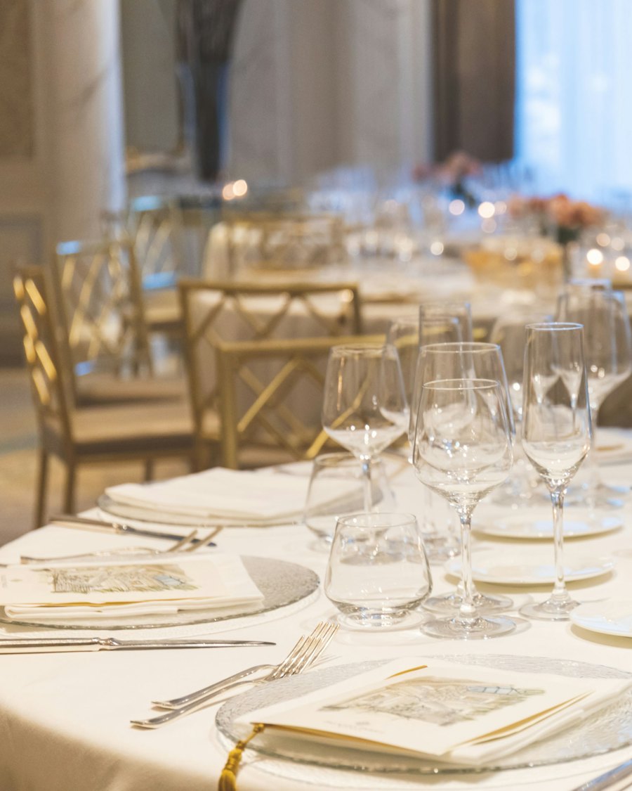 Elegant banquet table with fine glassware and roses