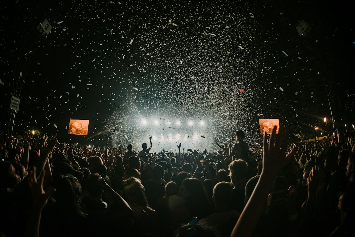 Confetti falling over a festival crowd at night