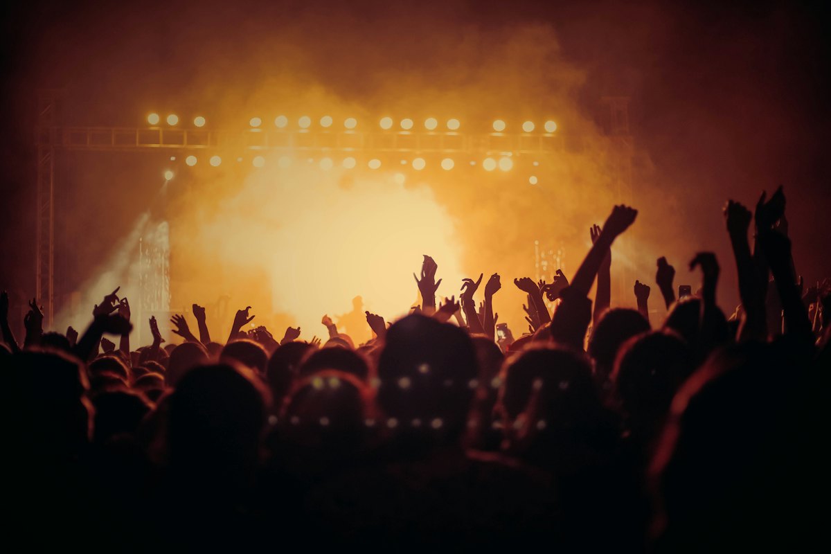 Warm stage lighting above a cheering crowd