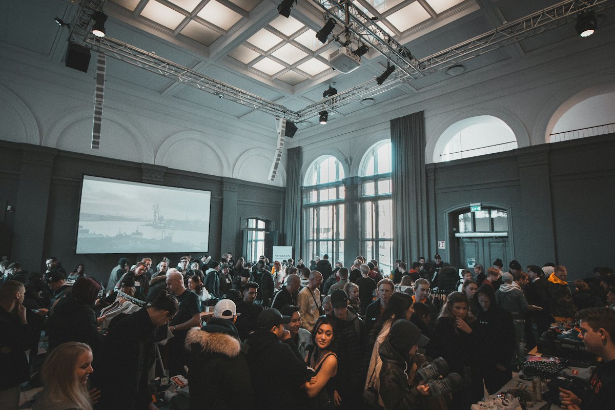 Large conference hall with delegates seated at round tables