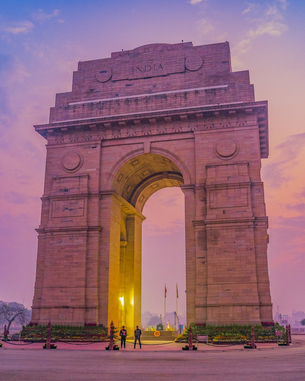 Memorial arch glowing against a pink twilight sky