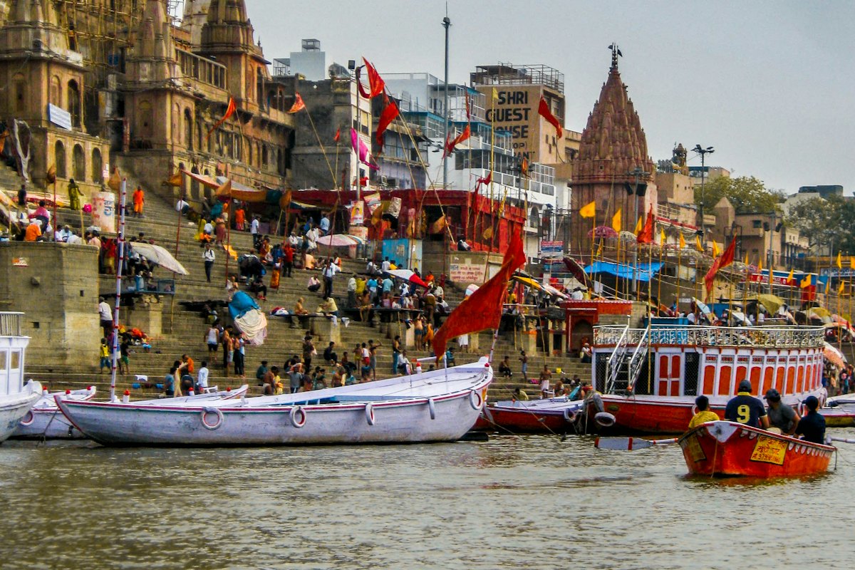 Riverside ghats and temples with boats at the water's edge