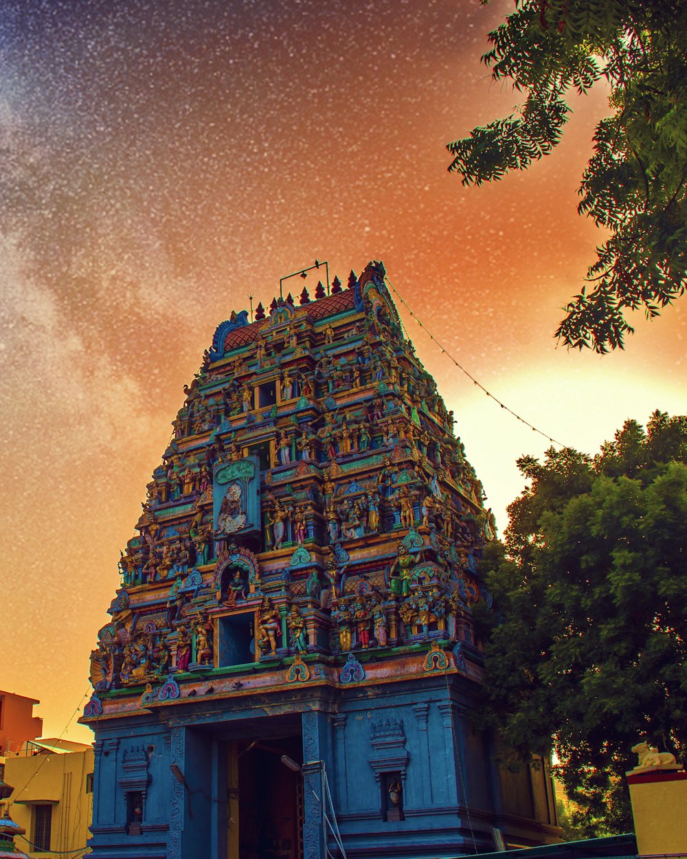 Ornate South Indian temple tower under a twilight sky