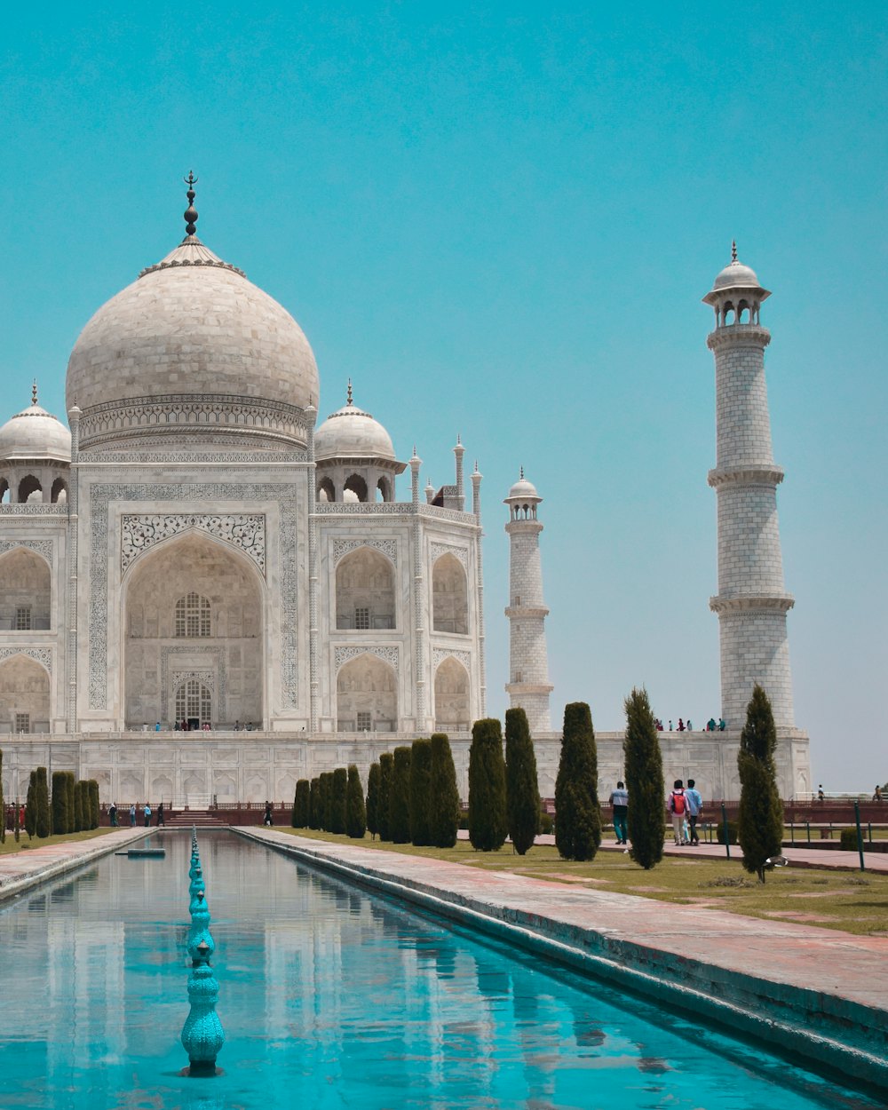 White marble monument beside a reflecting pool