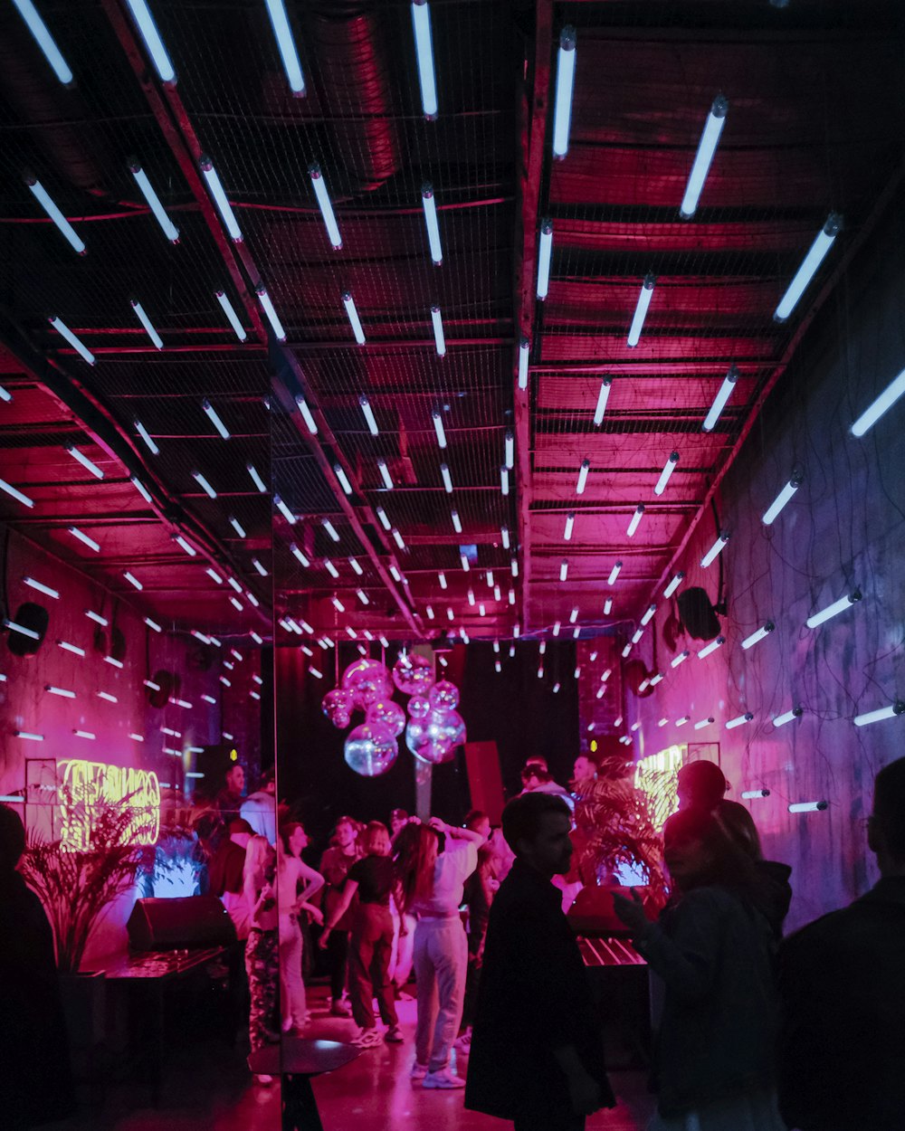 Immersive LED-lit corridor with a crowd inside