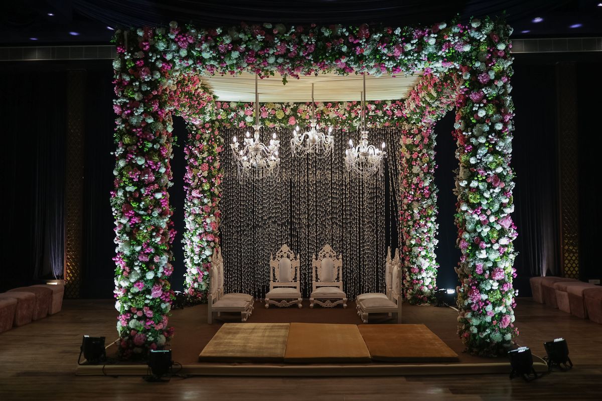 Floral wedding mandap with crystal chandeliers