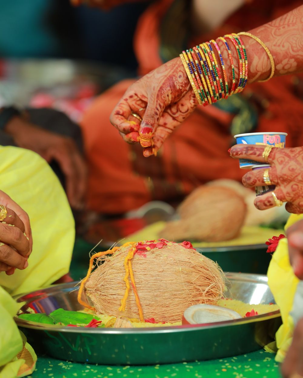 Bride's hands with henna and bangles during a wedding ritual