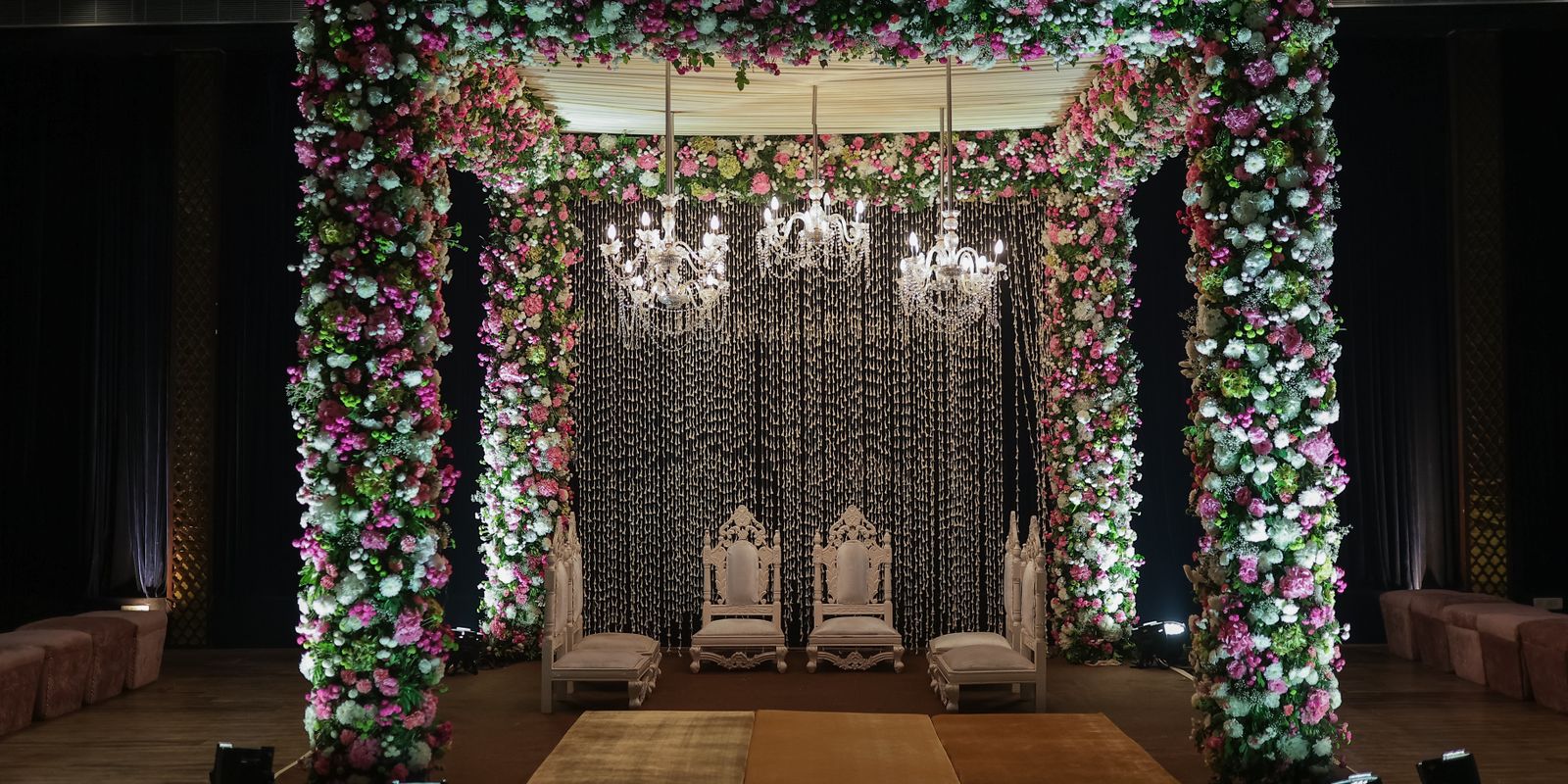 Floral Indian wedding mandap with crystal chandeliers