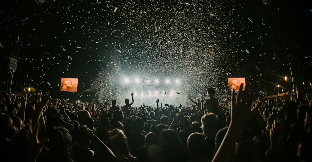 Confetti falling over a festival crowd at night