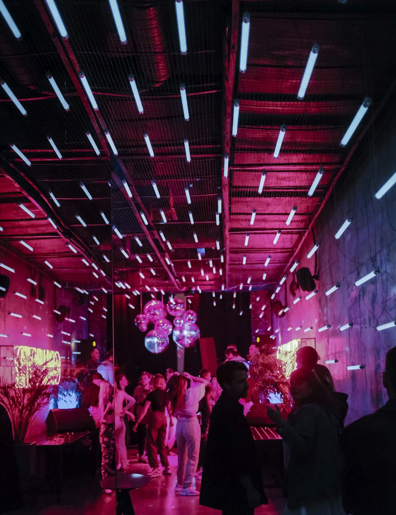 Immersive LED-lit corridor with a crowd inside