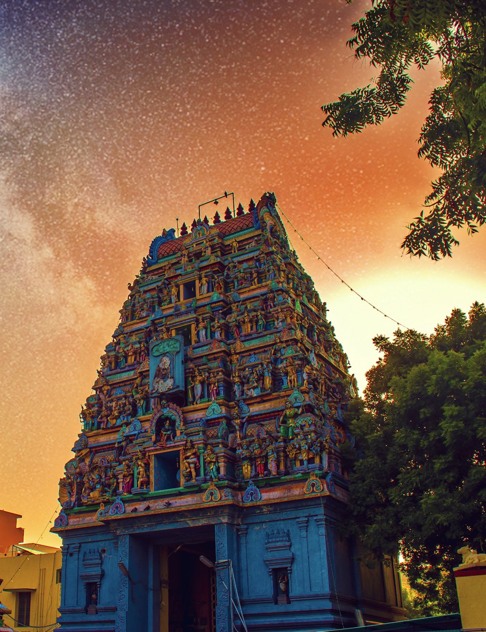 Ornate South Indian temple tower under a twilight sky