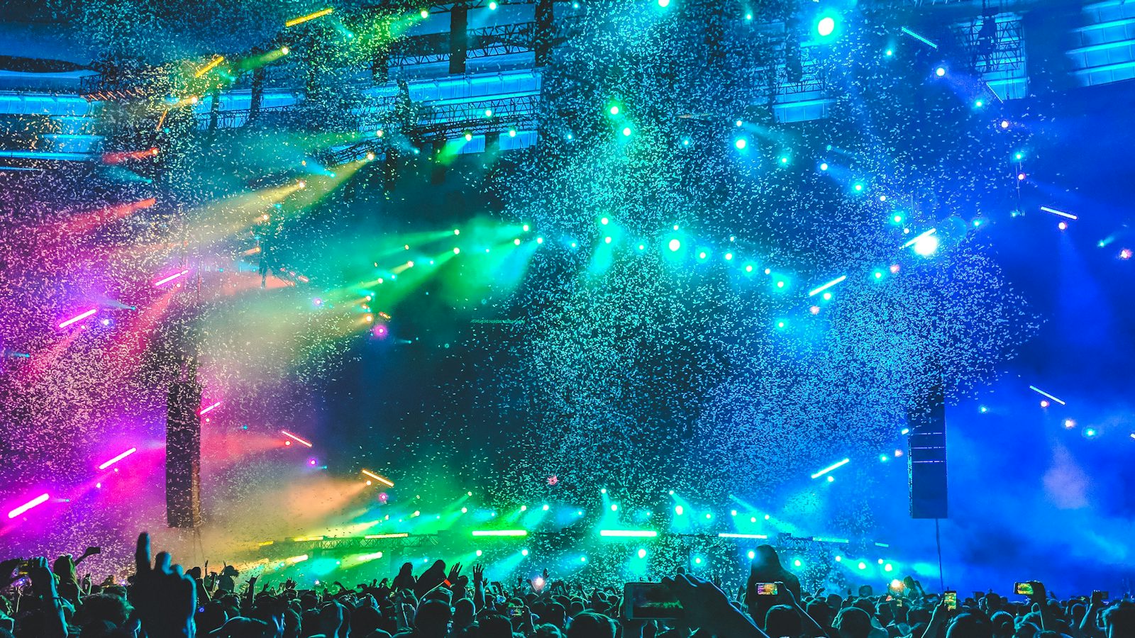 Vivid stage lighting and LED effects over an audience